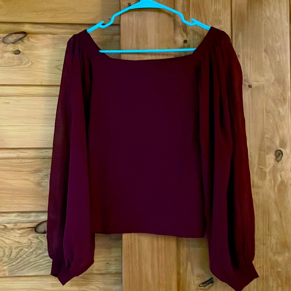 Lu Lu’s maroon sweater with shear sleeves